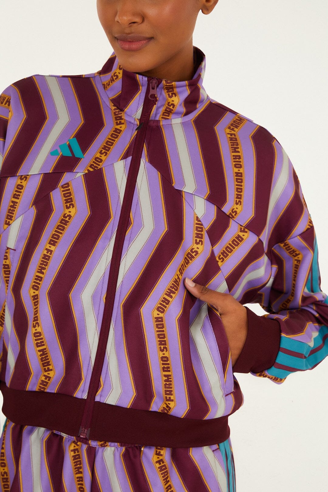 FARM Rio model wearing the Zig Zag Stripes Lilac Adidas Tiro Jacket