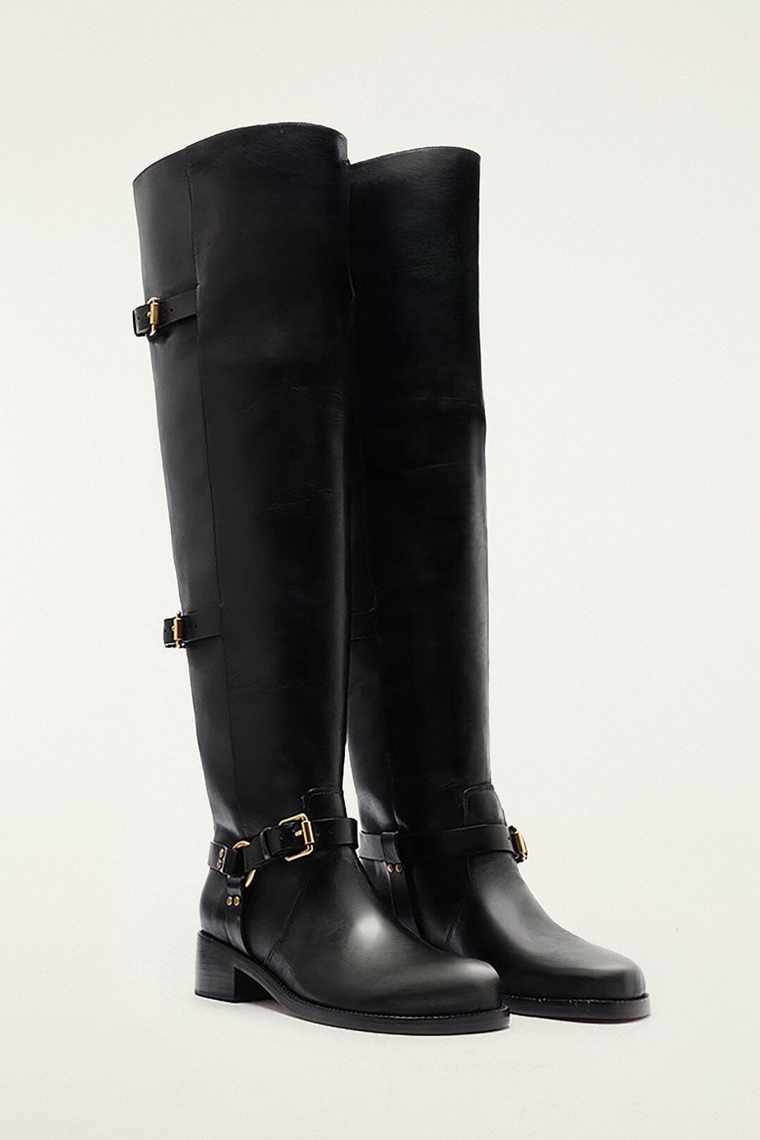 FARM Rio model wearing the Black Distressed Leather Buckled Over-The-Knee Boot