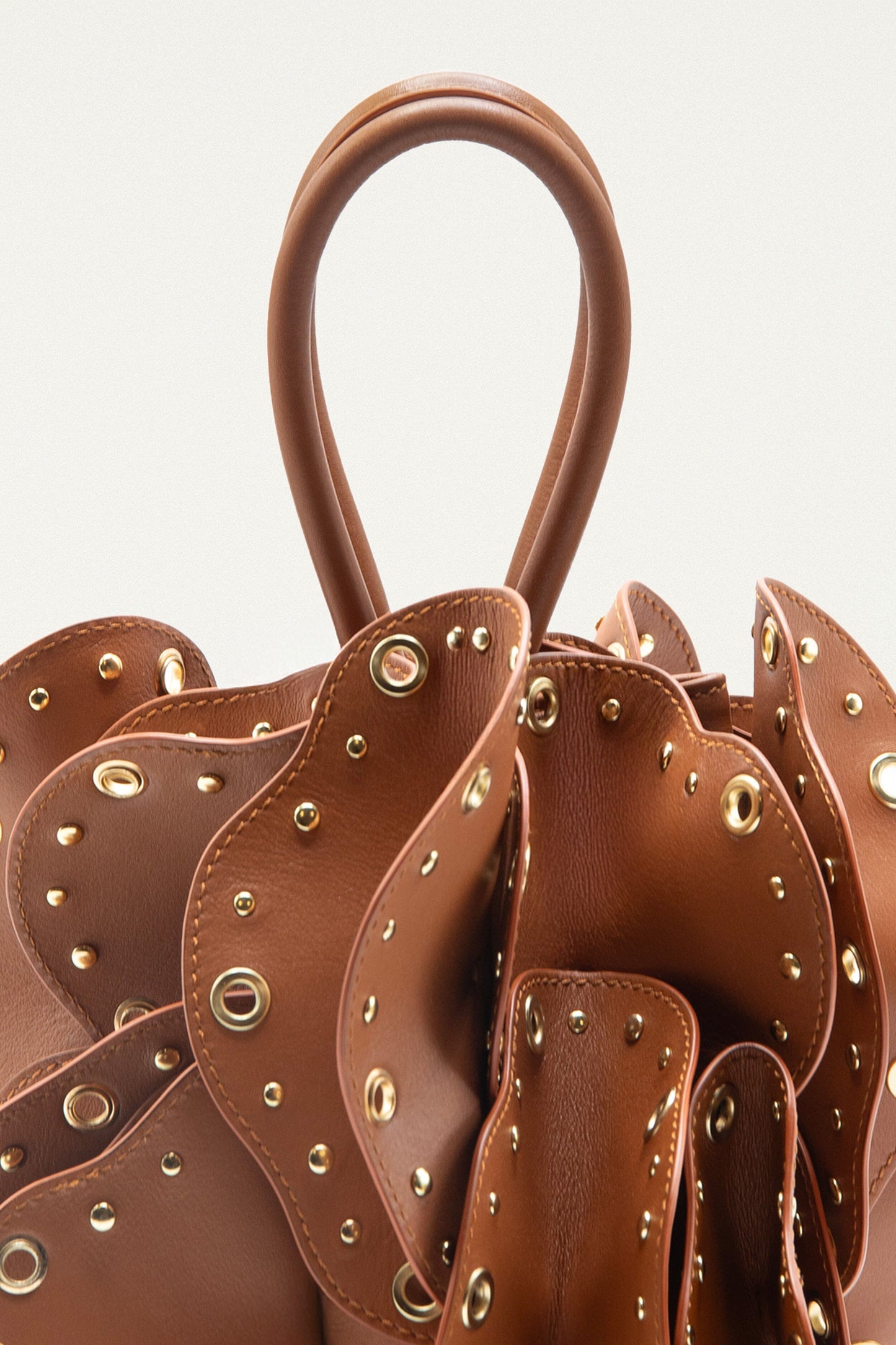 FARM Rio model wearing the Brown Leather Studded Flower Bag
