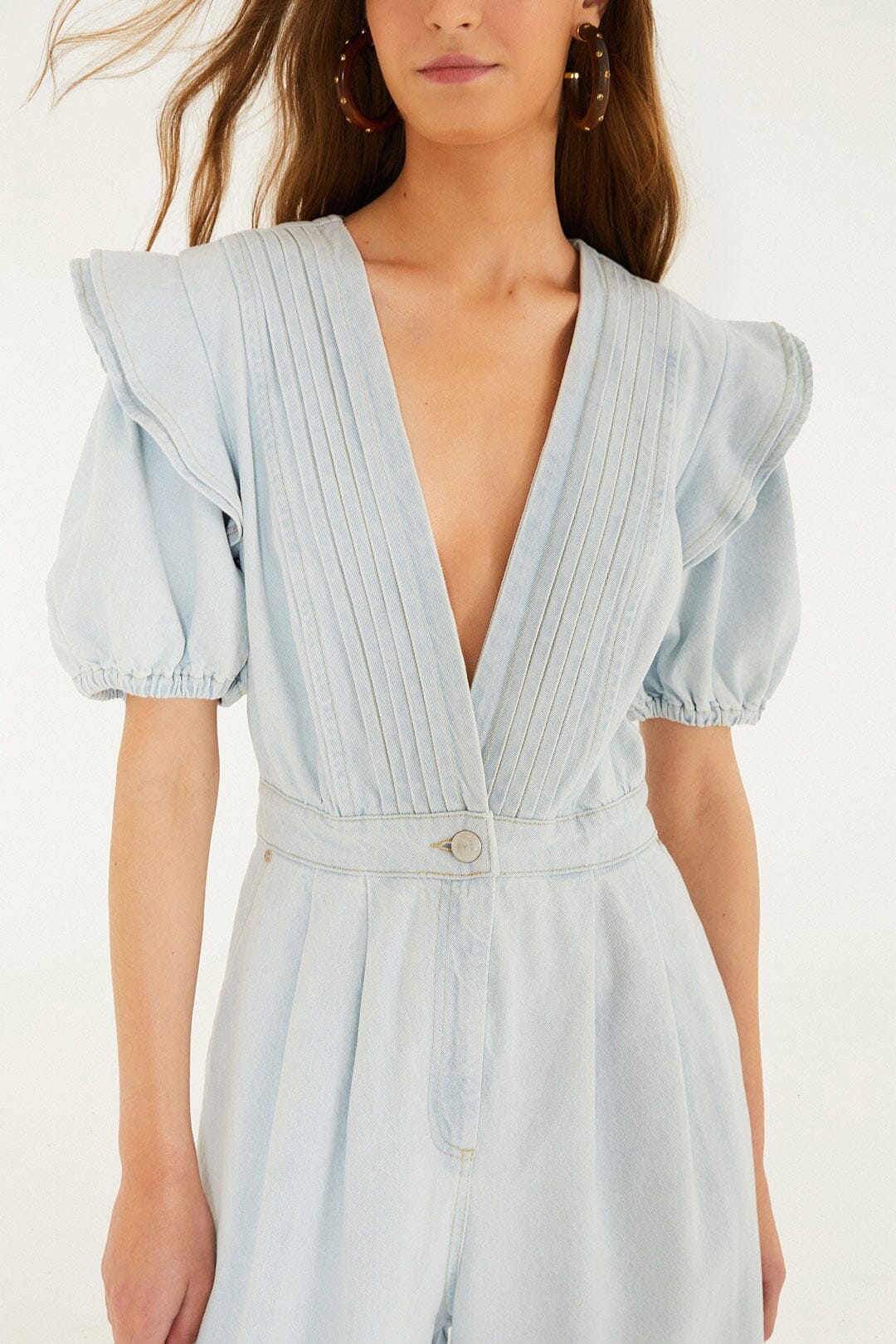 FARM Rio model wearing the Denim V Neck Pleated Ruffled Jumpsuit