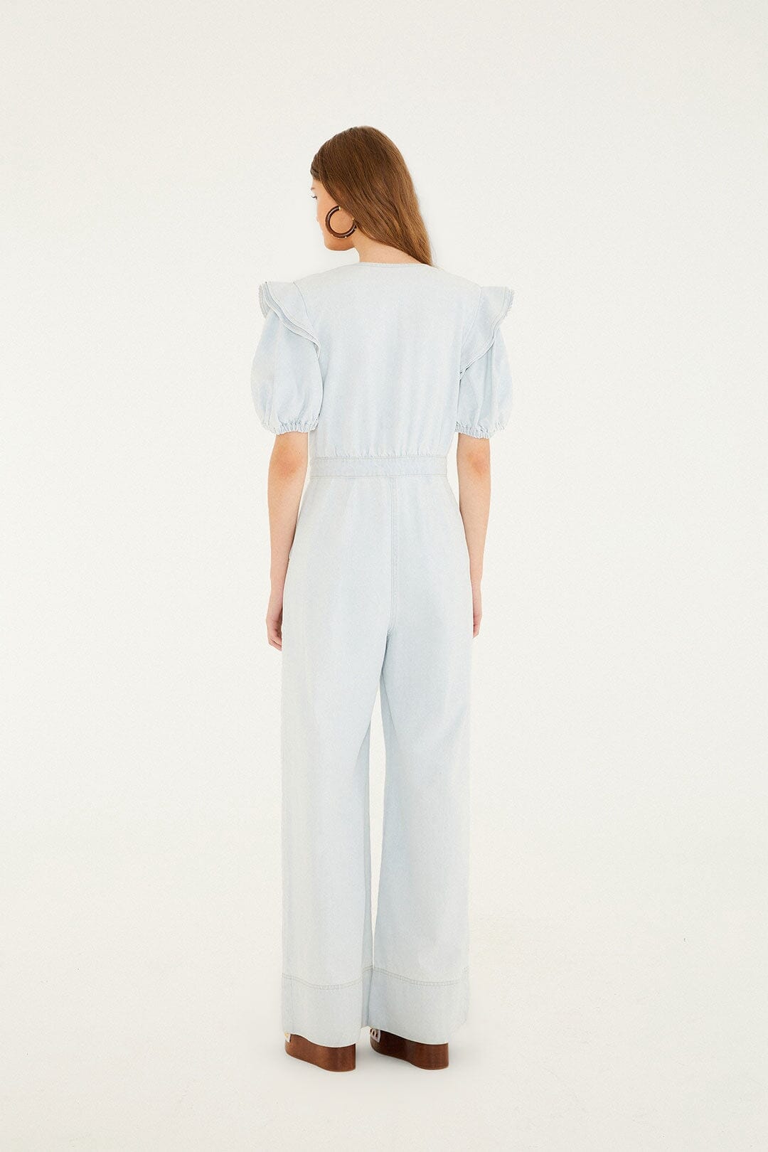 FARM Rio model wearing the Denim V Neck Pleated Ruffled Jumpsuit