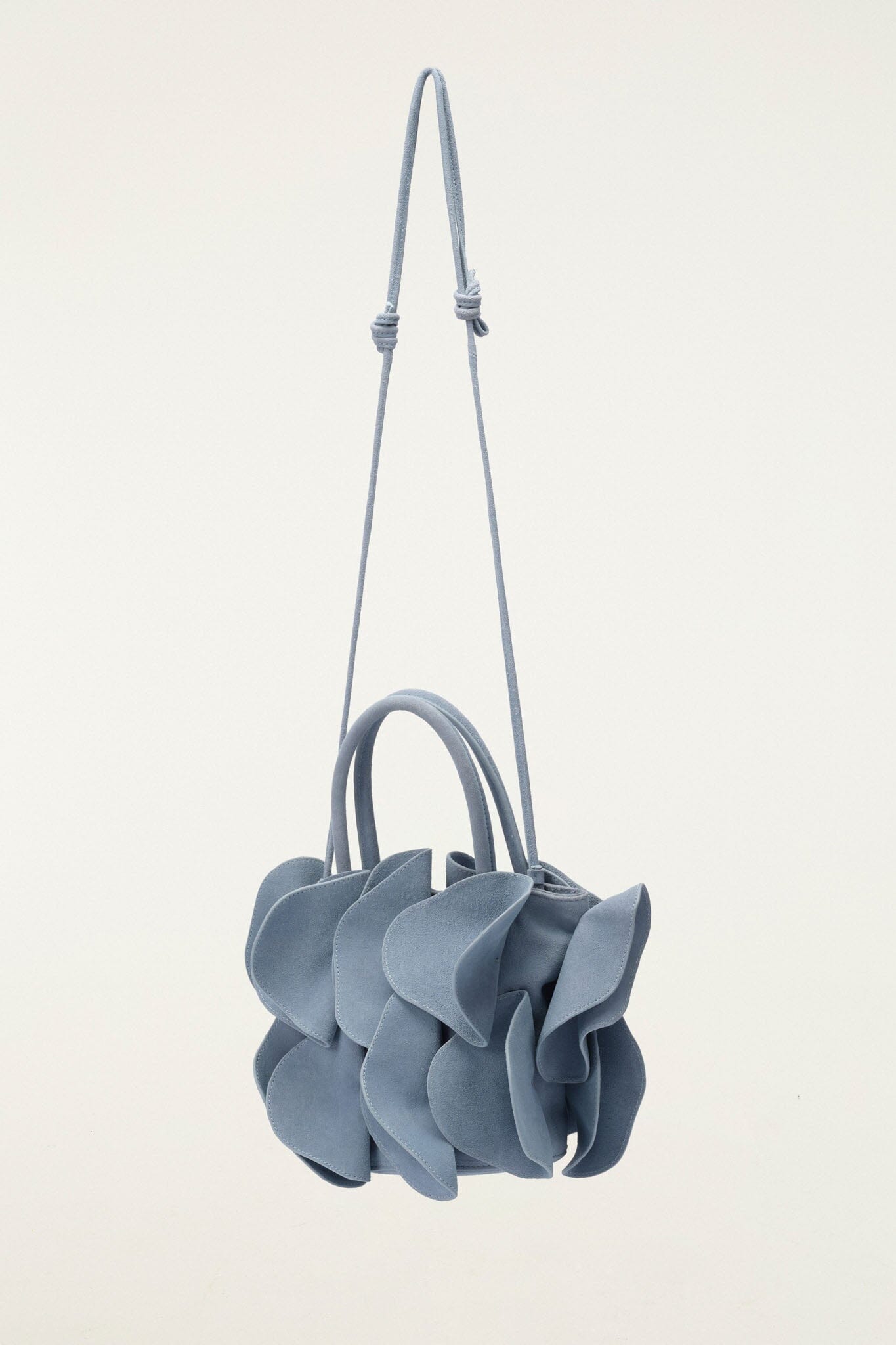 FARM Rio model wearing the Light Blue Suede Flower Handbag